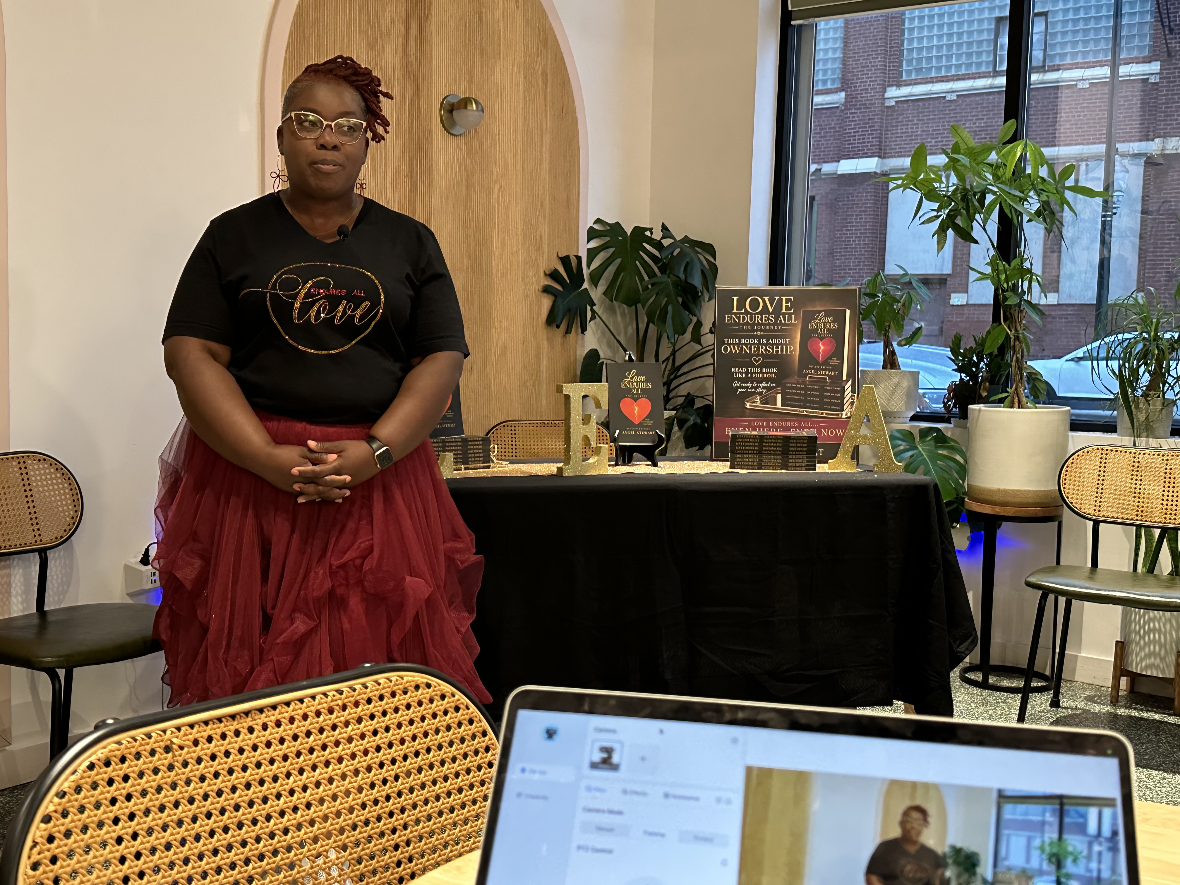 Angel Stewart at the Love Endures All book table